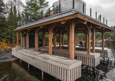 Full view from the water of timber framed boathouse.