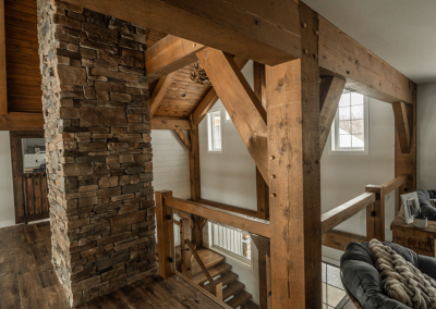 Interior showing chimney and entrance of large timber framed home.