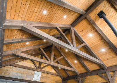 Timber framed roof with wall clock.