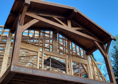 Timber framed entryway under construction.