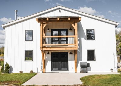 Timber frame entryway and balcony on custom shop.