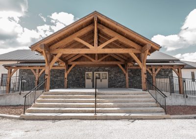 Gable view of timber framed entry on church.